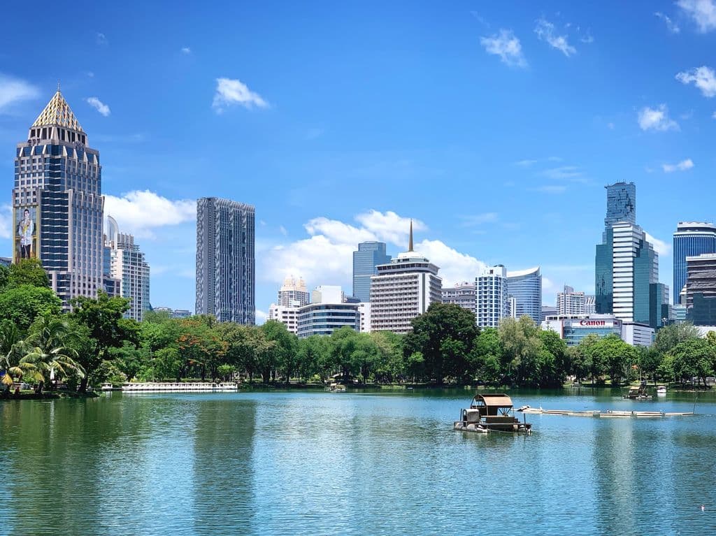 Bangkok skyline reflected in Lumphini Park lake, by Sergei Gussev