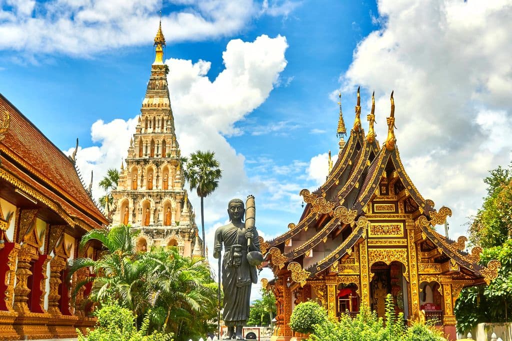 Standing statue and temple landmark in Thailand, by Mathew Schwartz