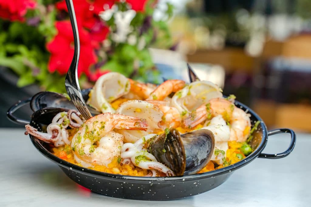 Paella served at a Barcelona restaurant table, by Denys Gromov