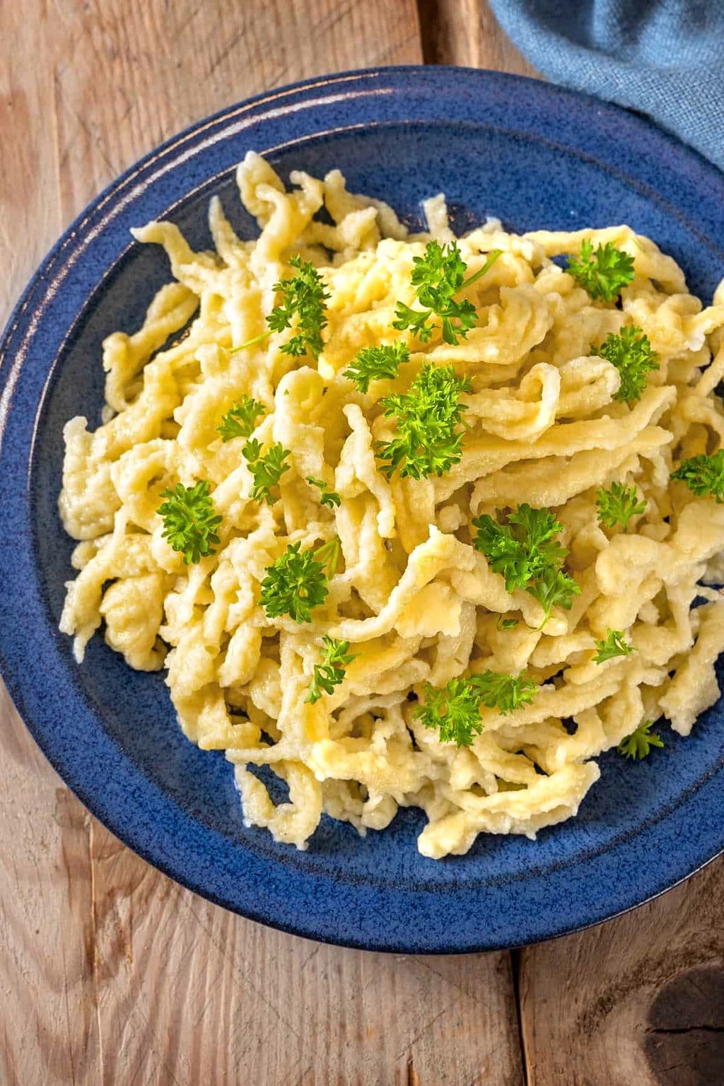 Homemade German spaetzle noodles in a pan, by The Daring Gourmet
