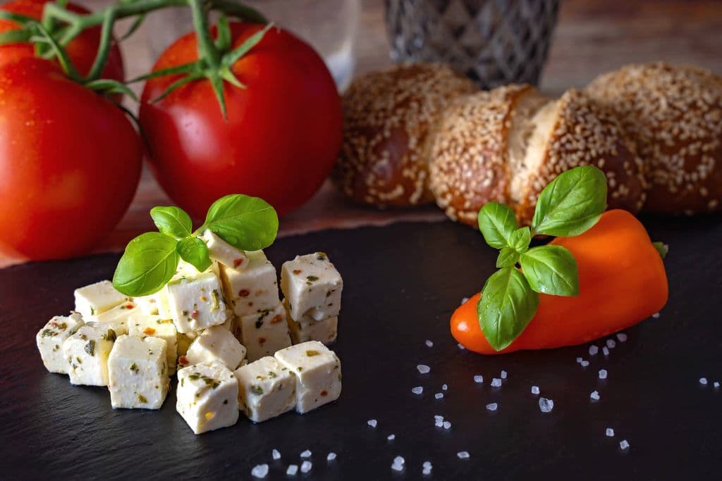 Feta cheese with tomatoes, bread, and herbs, by Gundula Vogel