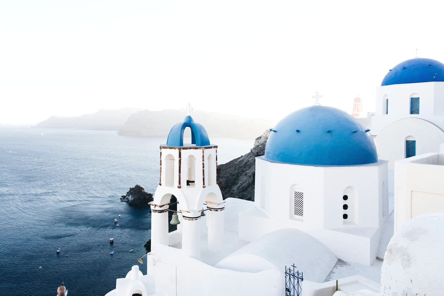 Santorini white buildings and caldera view in Greece, by Jonathan Gallegos