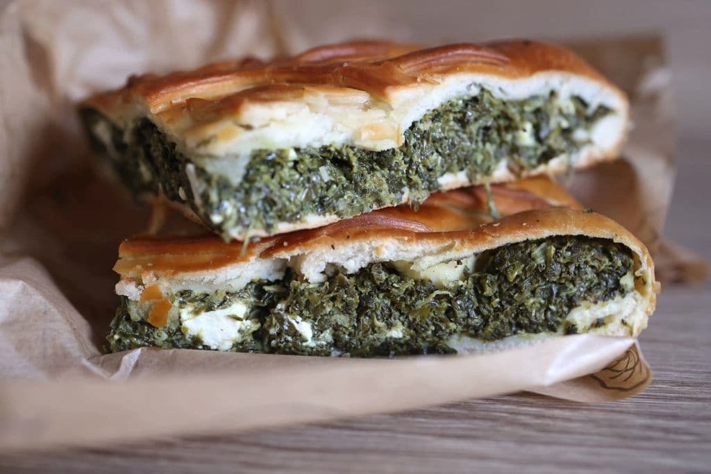 Spanakopita slices with spinach, feta, and phyllo pastry, by Valeria Boltneva