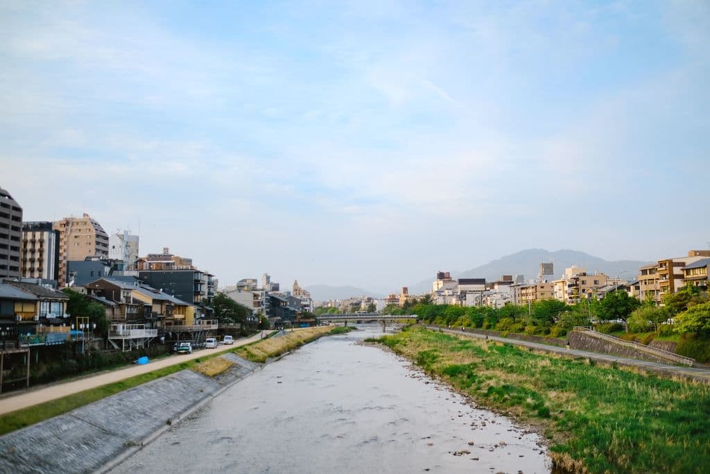 Kamo River with traditional riverside buildings in Kyoto, by Ayyeee Ayyeee