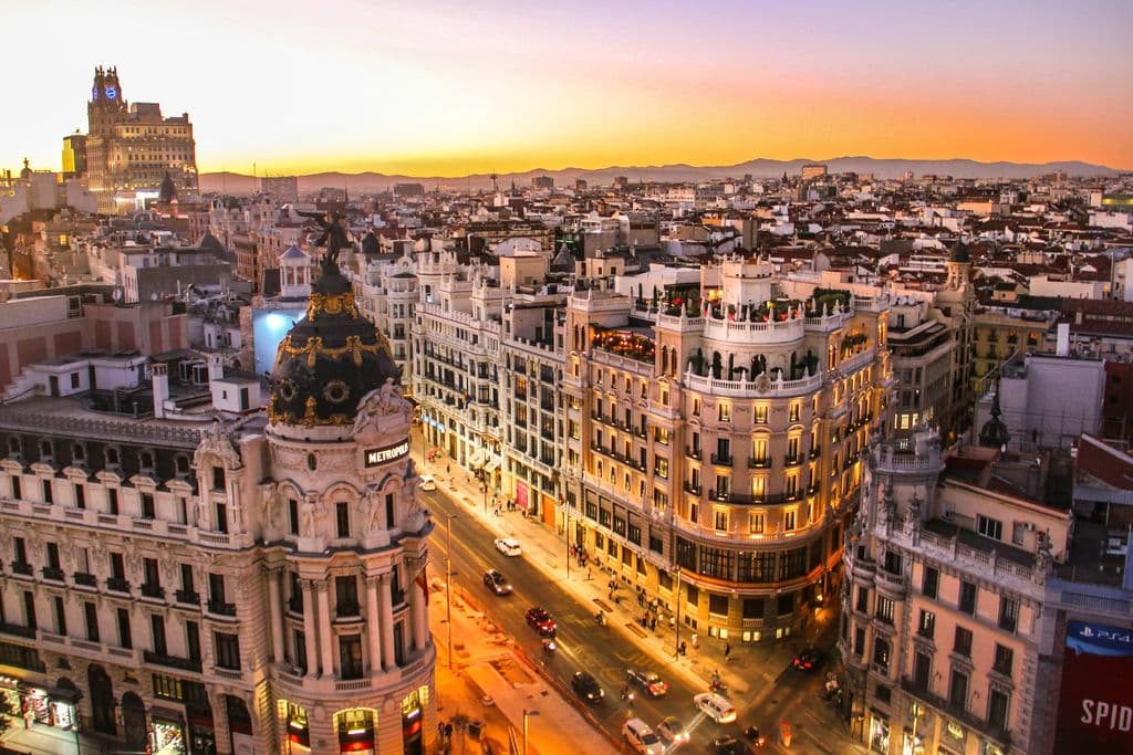 Aerial view of Gran Vía traffic between Madrid buildings, by Florian Wehde