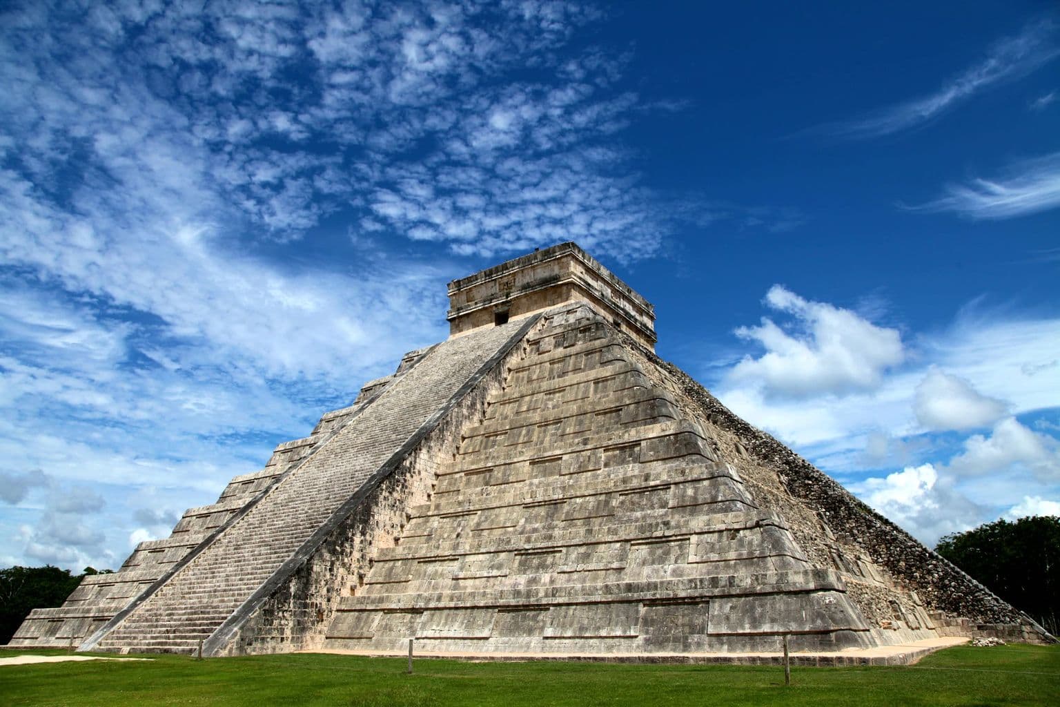 Chichen Itza pyramid under a blue sky in Mexico, by Mario La Pergola