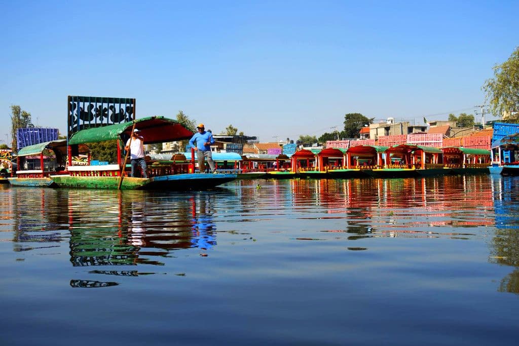Colorful trajineras on Xochimilco canals in Mexico City, by Sarah Ramírez