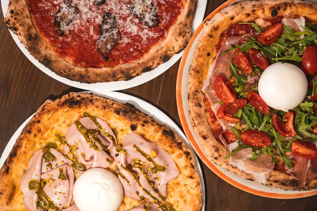 Pizza table inside a Milan pizzeria, by Giona Mason