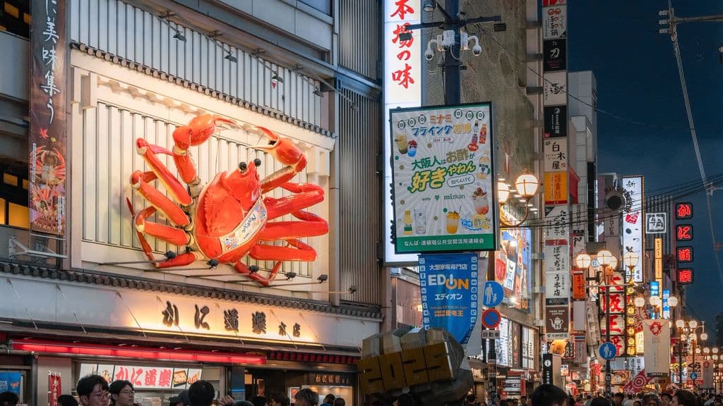 Giant crab sign on a busy Dotonbori food street, by Royce Ho