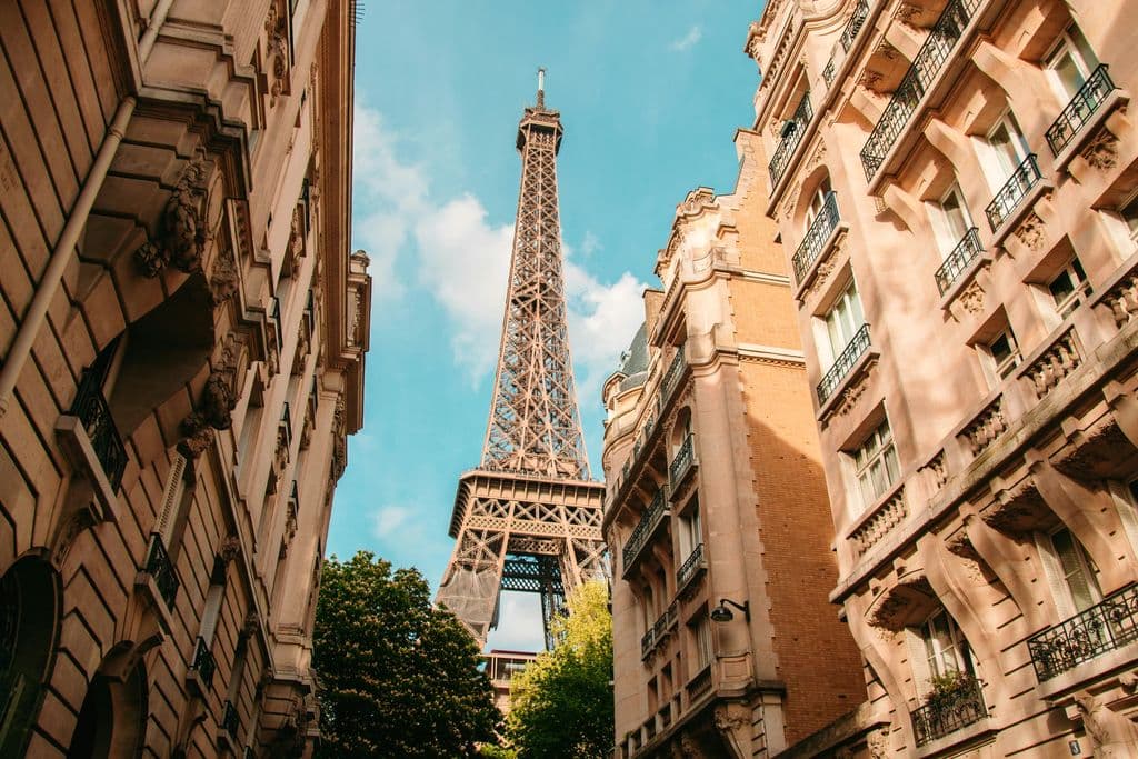 Eiffel Tower above Paris rooftops during daytime, by Juan Ordonez