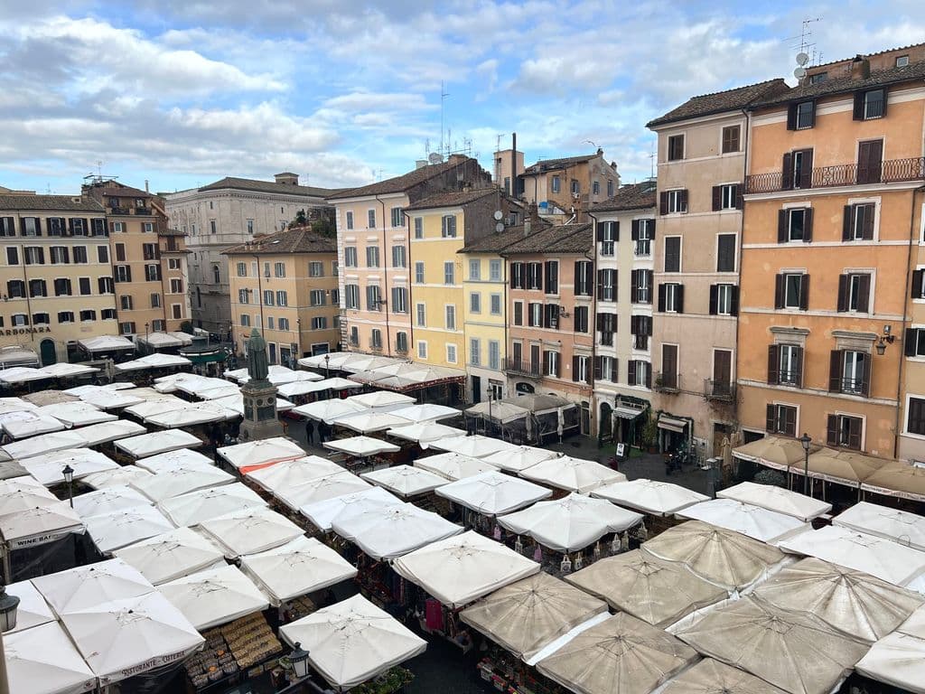 Campo de’ Fiori market and colorful buildings in Rome, by Martin Alargent