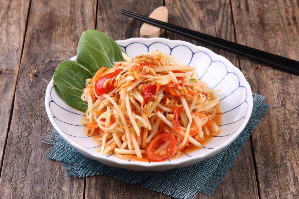 Som tam papaya salad with tomato and fresh greens, by UNDO KIM
