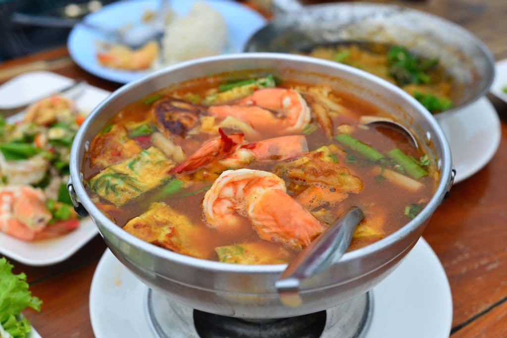 Tom yum goong shrimp soup with shrimp and herbs, by @ Nine