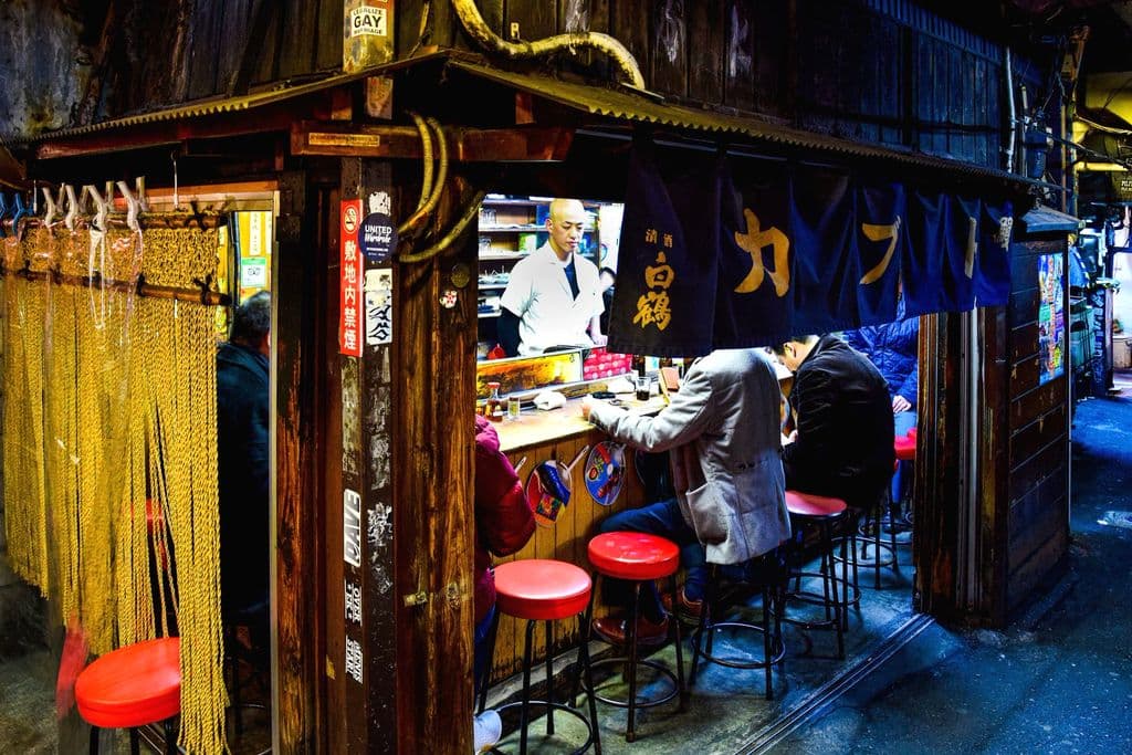 People eating in Omoide Yokocho alley in Shinjuku, Tokyo, by AXP Photography