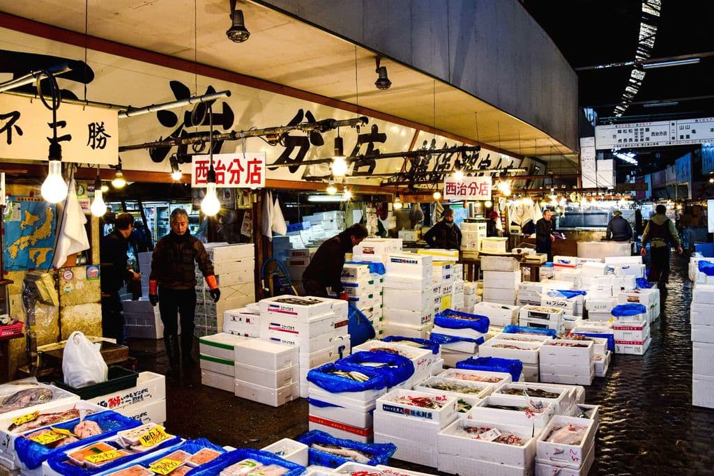 Seafood vendors working at Tsukiji Outer Market in Tokyo, by AXP Photography
