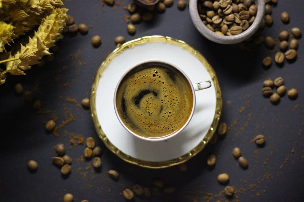 Turkish coffee in a small cup with beans, by Hatice Esma DEMİREL