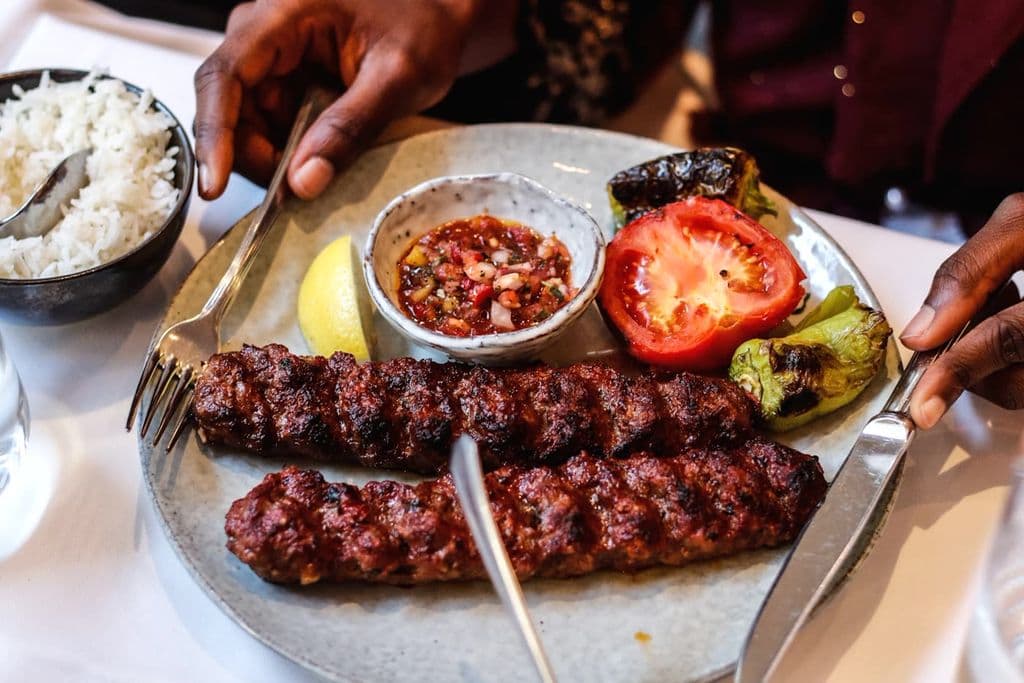 Grilled Turkish kebab served with dips and salad, by Suad Kamardeen