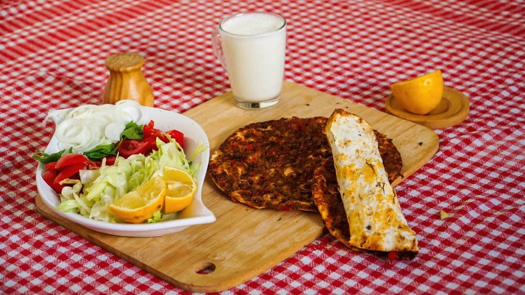 Turkish lahmacun served with salad and ayran, by Cihan Çimen