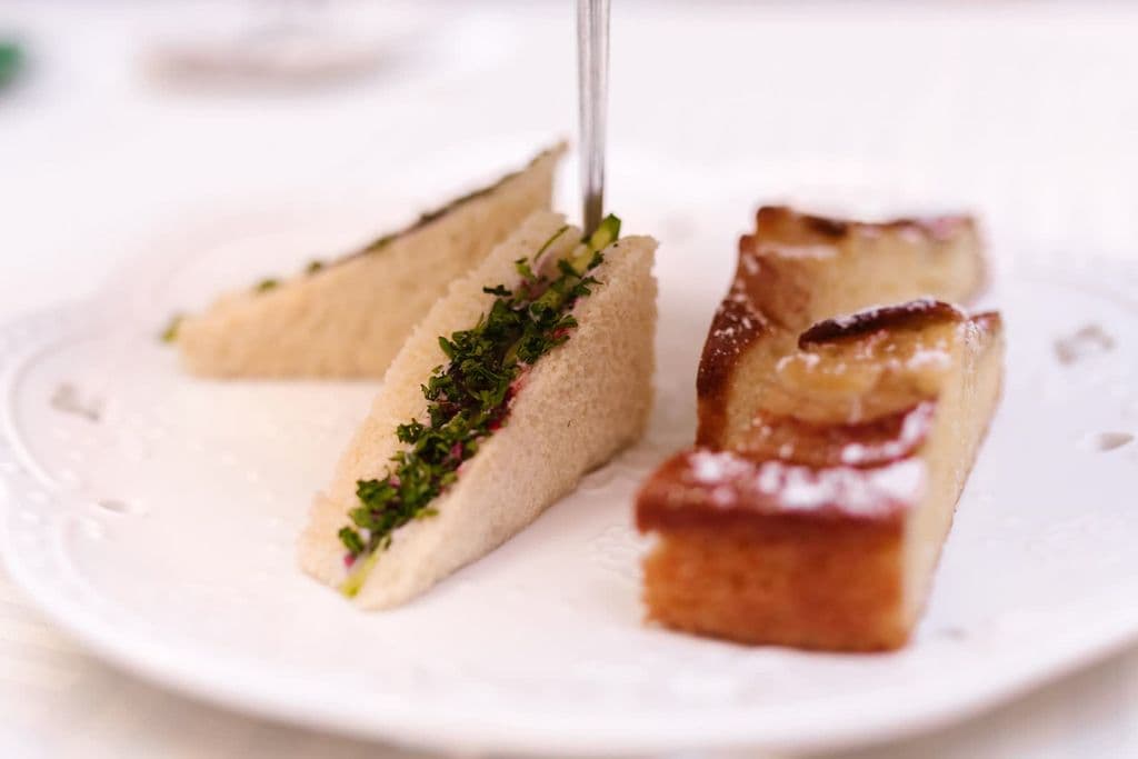 Afternoon tea sandwiches and cake on fine china, by RDNE Stock project