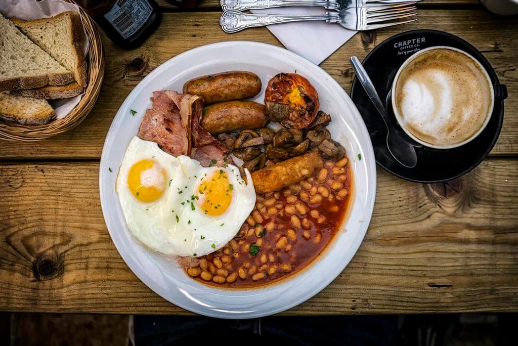 Full English breakfast with eggs, beans, sausage, and toast, by Ajeet Panesar