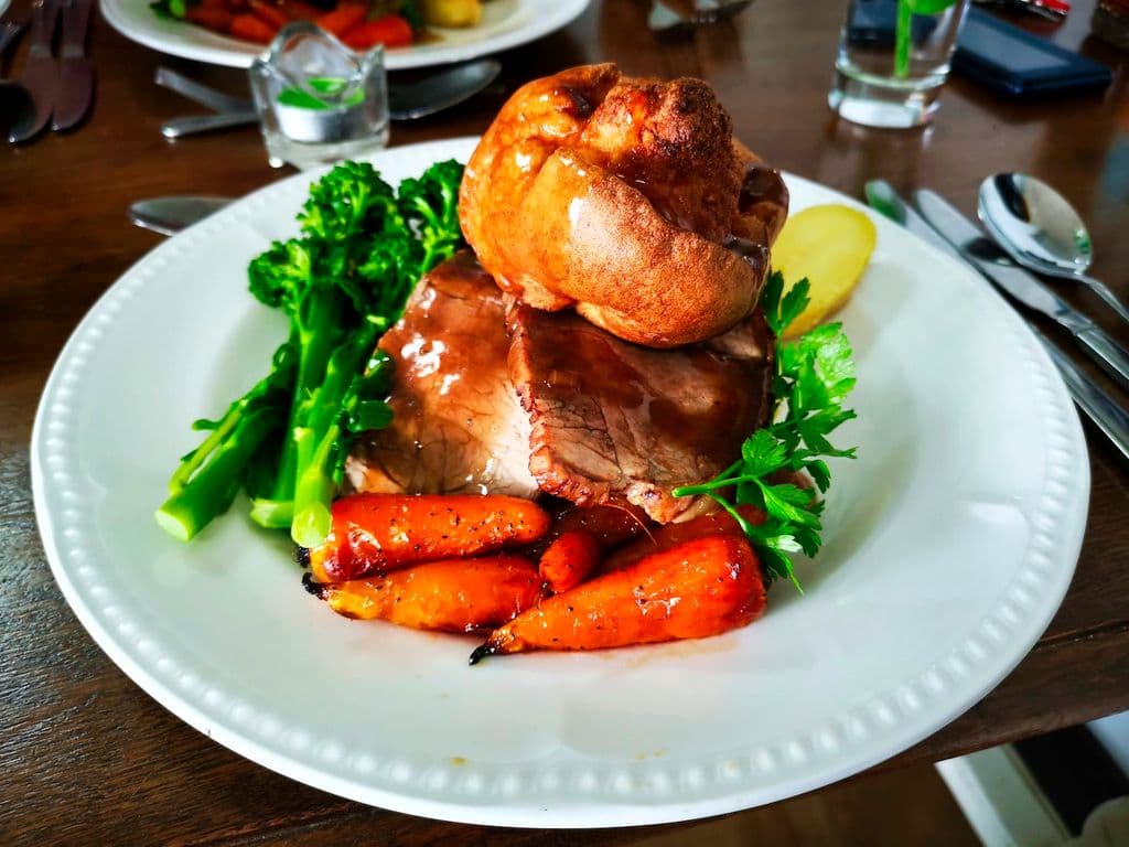 Sunday roast with Yorkshire pudding, meat, and vegetables, by Lisa Baker