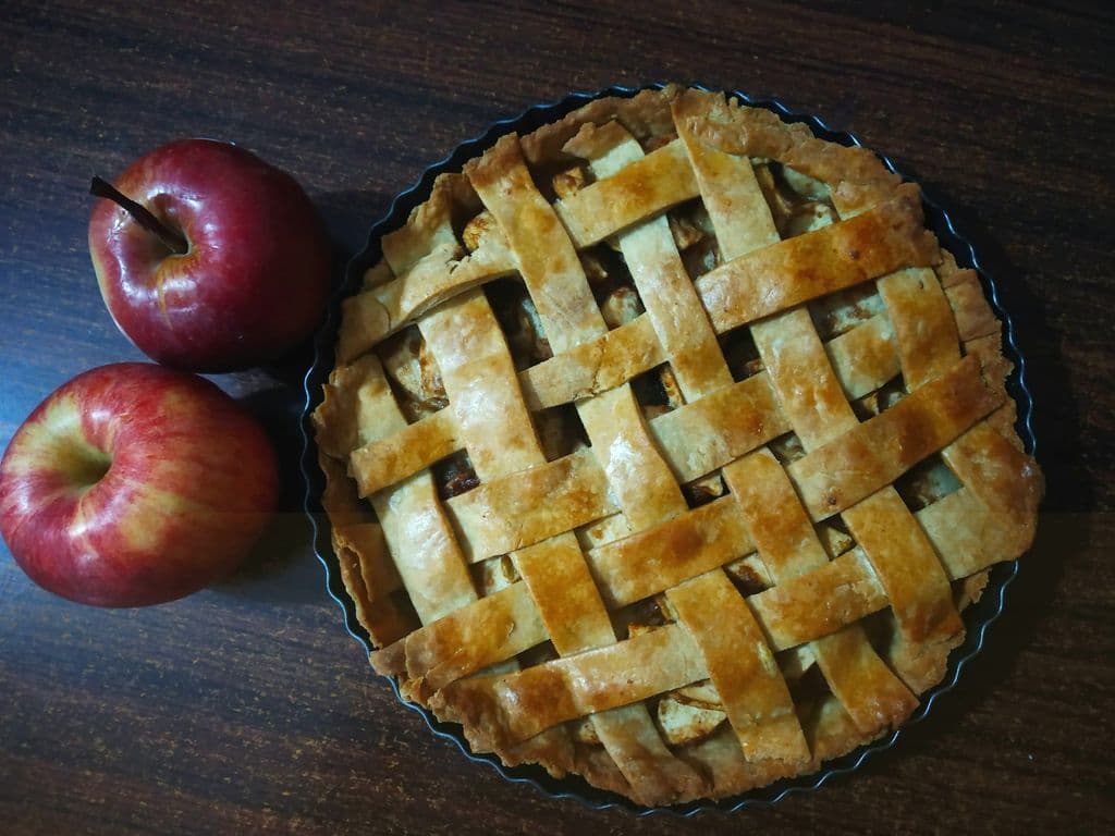 Apple pie with red apples on the side, by Kavya P K