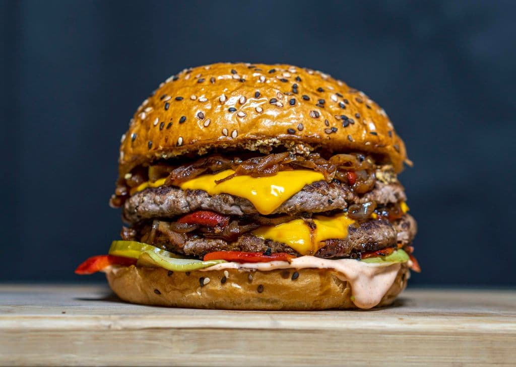 Double patty cheeseburger with melted cheese, by amirali mirhashemian