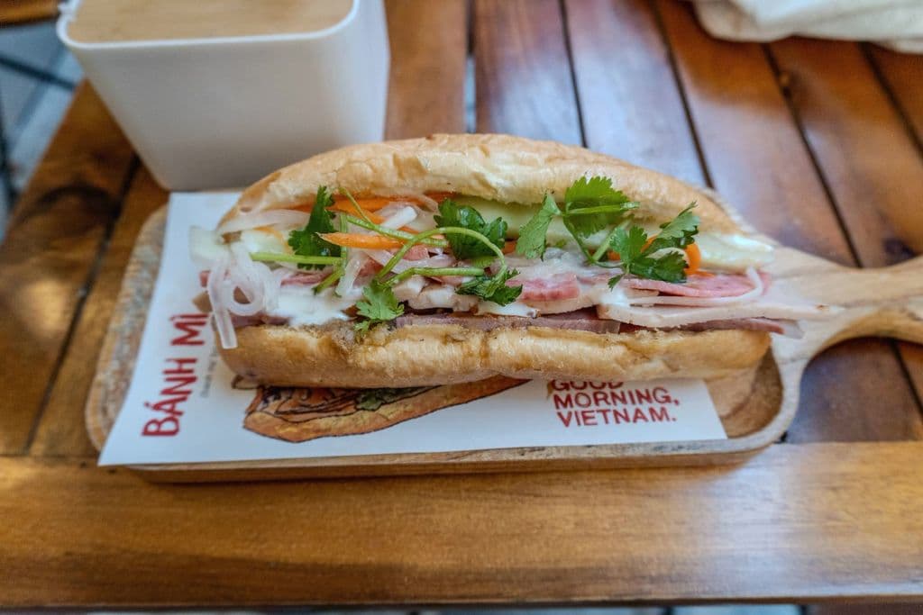 Vietnamese bánh mì sandwich with herbs and pickles, by Jordan Coleman